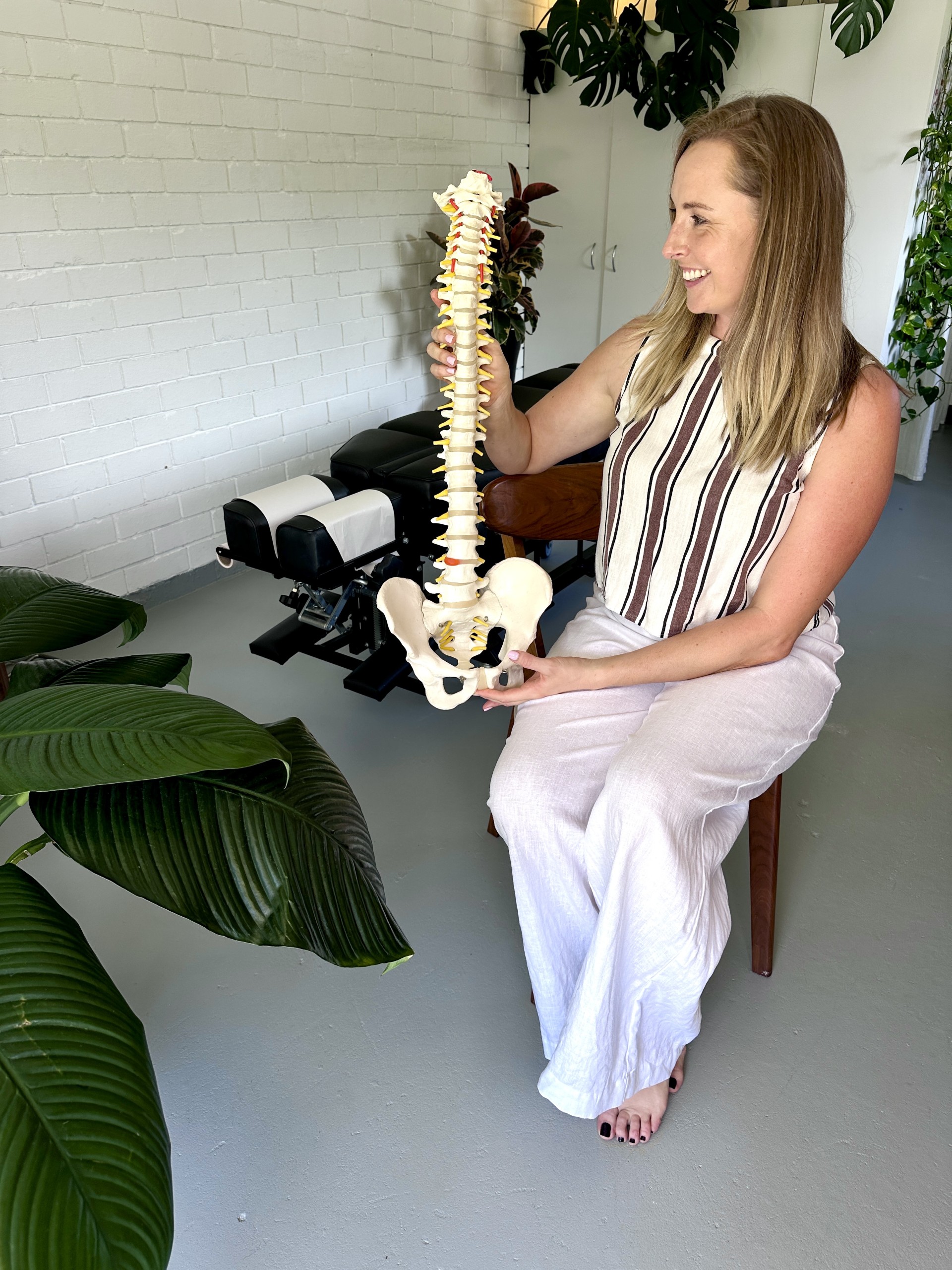 Kasia holding spine model seated